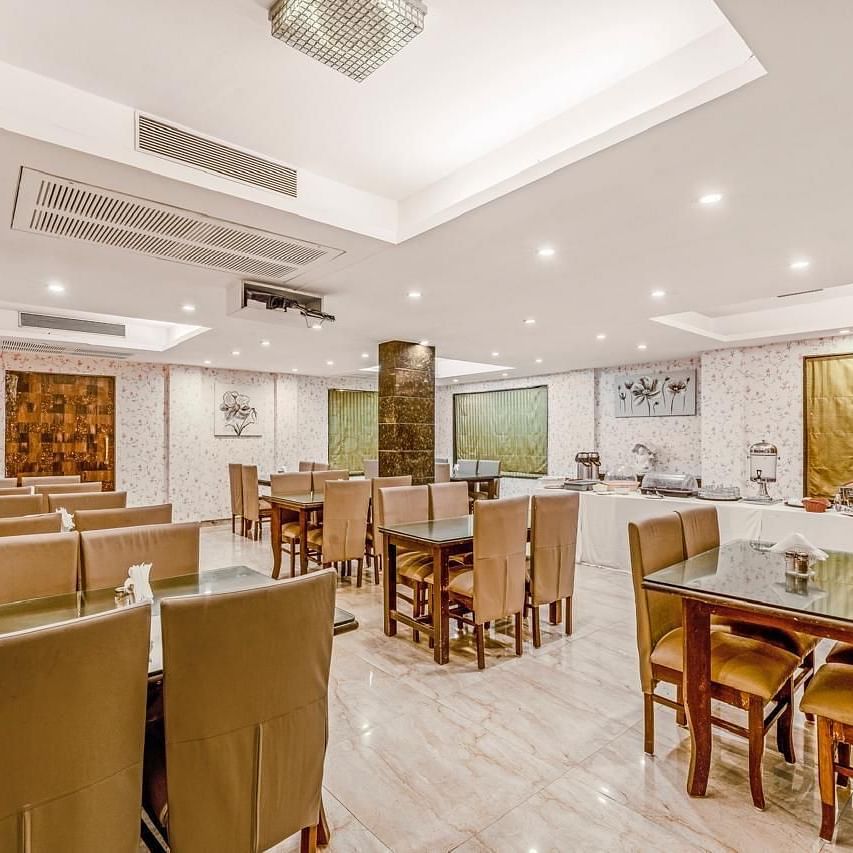 Image of a restaurant with seating area and lights on the ceiling at Calux Joia Do Mar Resort, Goa.