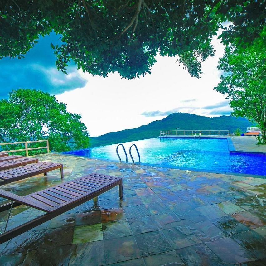 Chairs and a Swimming Pool at Grand Palace, Yercaud