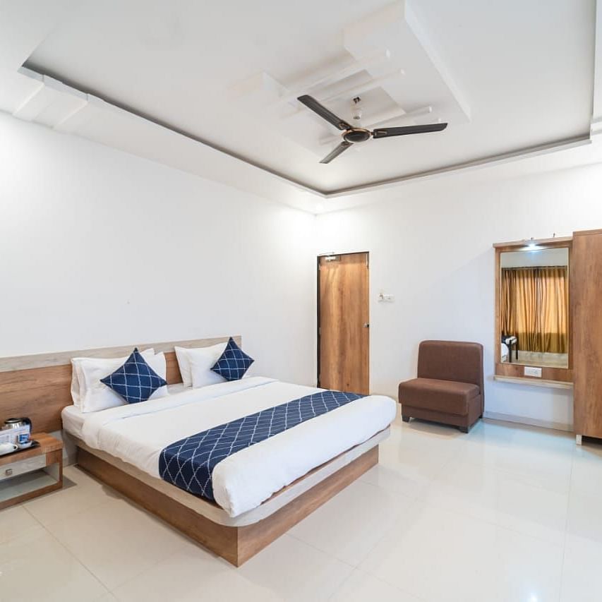 Penthouse Suite with Balcony with a king size bed, a nightstand, a chair, and a wardrobe.