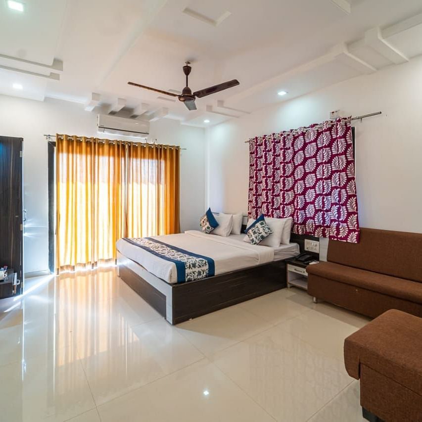 Deluxe Valley View Room featuring a king size bed, a sofa, and a television. 