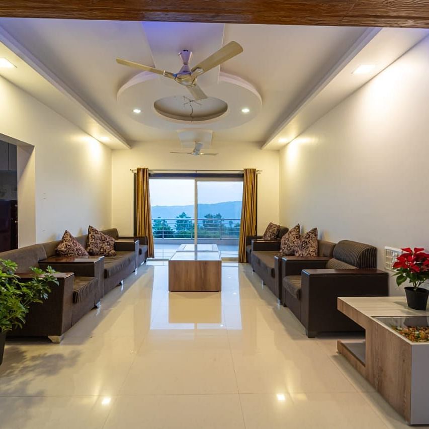 A hotel lobby with seating areas and a view to the outside.