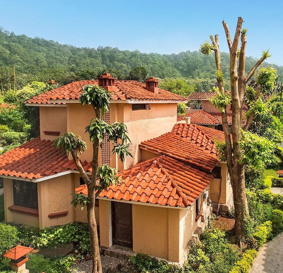 An image of a villa with many rooms and cottages amidst the trees - The Riverview Retreat,  Corbett