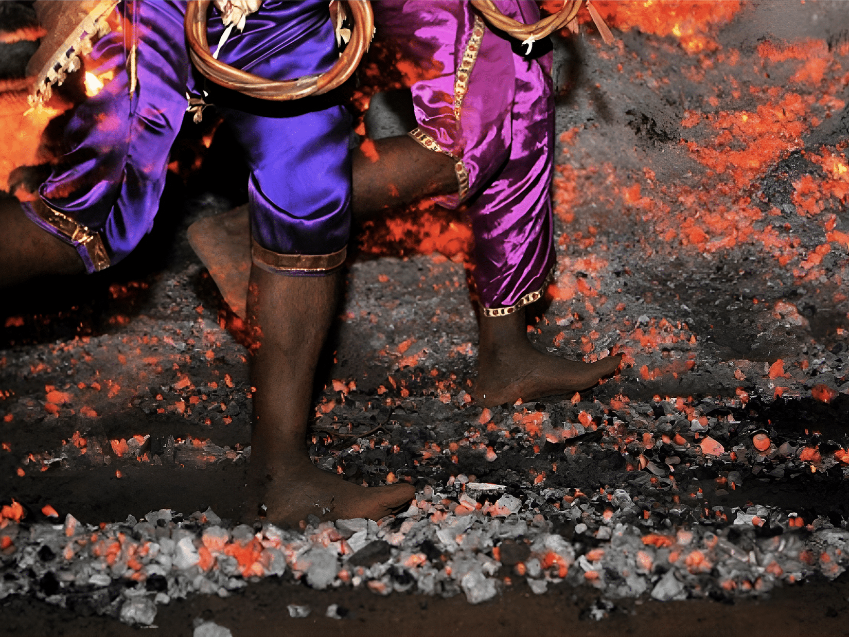 A person walking over hot coals during a religious ritual, in Goa.