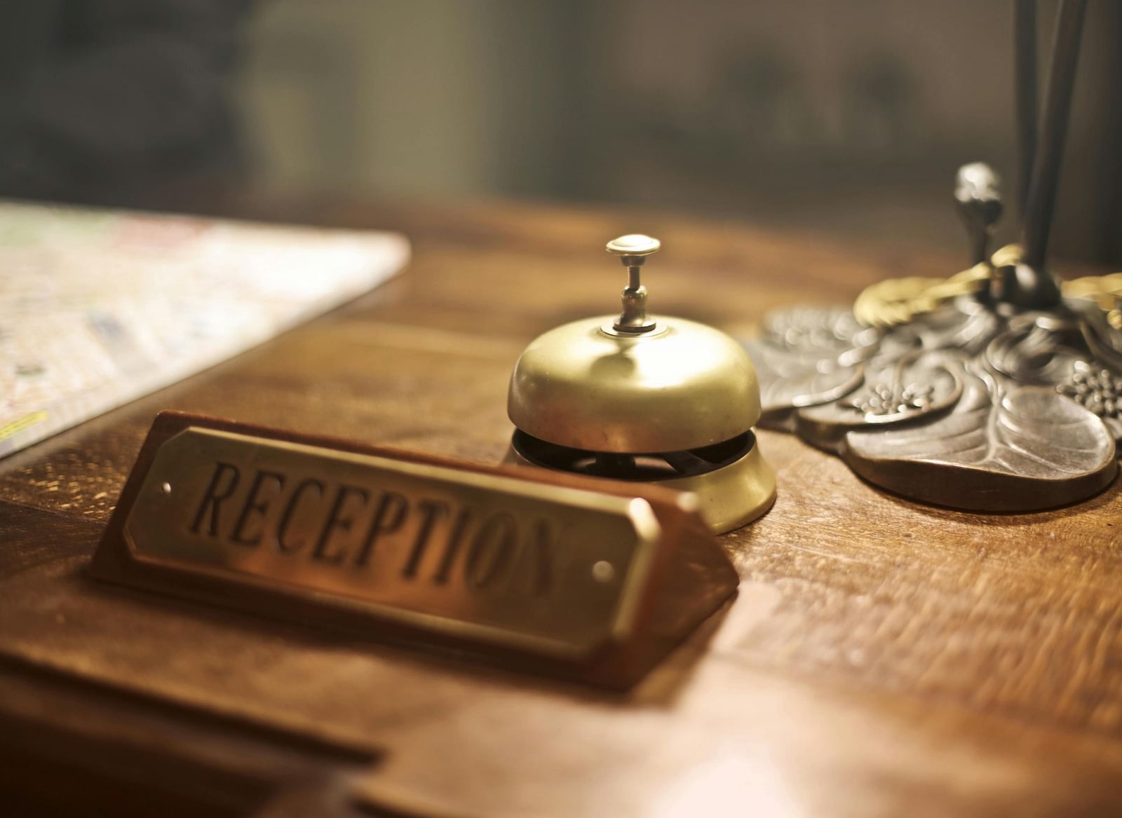 A reception desk with a bell and nameplate.
