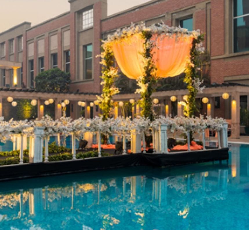 View of seating arrangement besides the swimming pool at Nirvana Luxury Hotel, Ludhiana