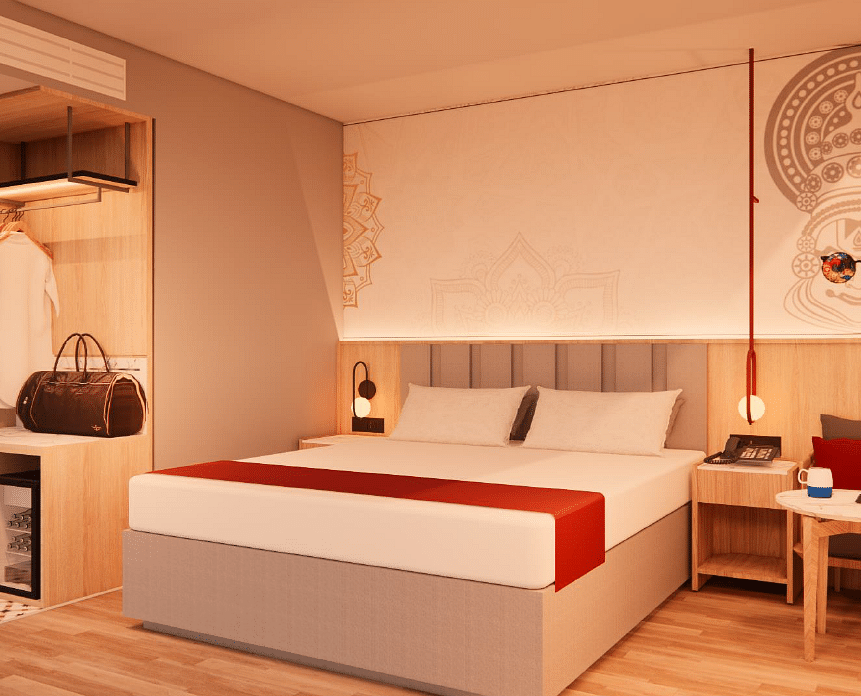 A spacious room with warm lighting, a bed, bedside tables, a couch, and a coffee table - TGI Oberon, Koramangala