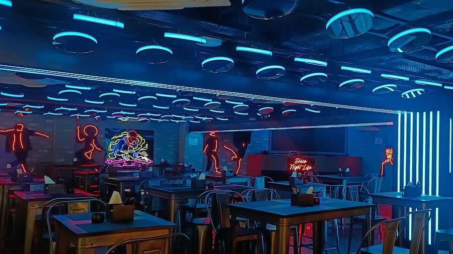 Disco Night Life dining area at Wonder Country Club and Resort, Kharagpur showcasing elegant neon lighting, stylish decor, and well-arranged tables