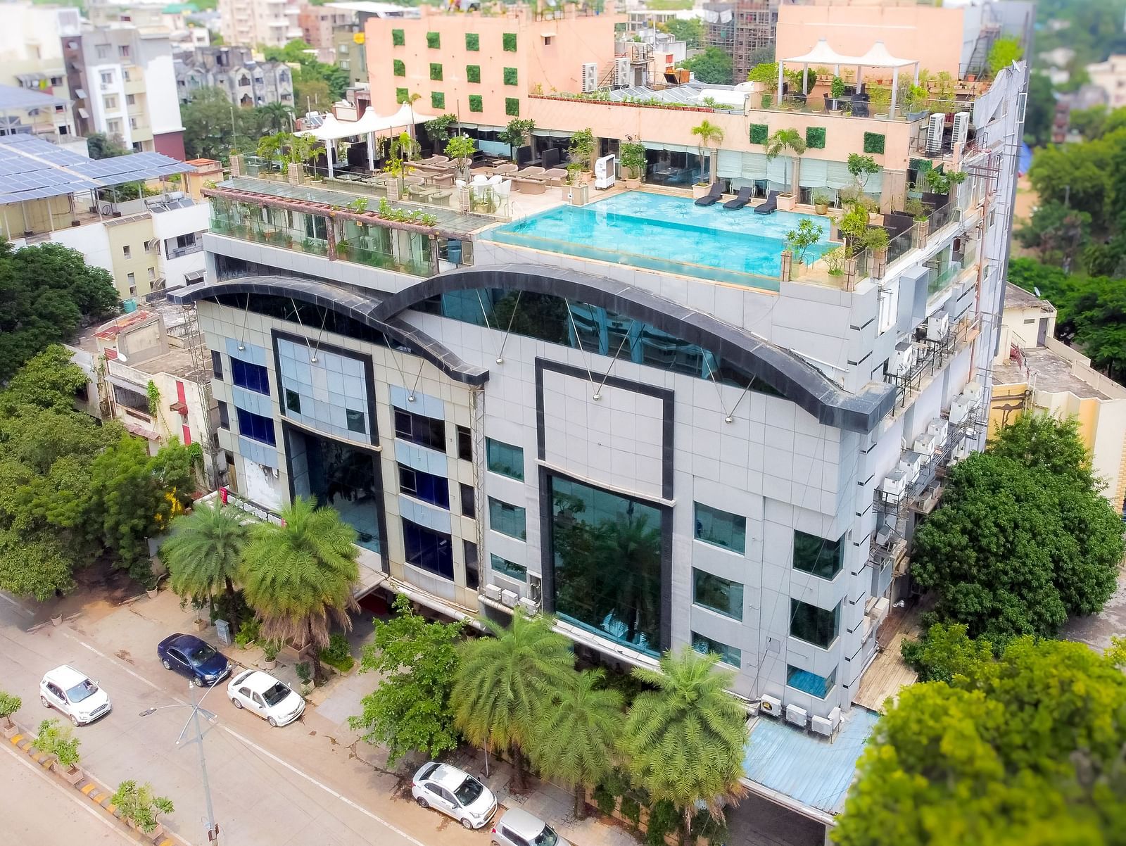 An aerial view of Hotel Ashok Nagpur, featuring a modern building with greenery surrounding it. 