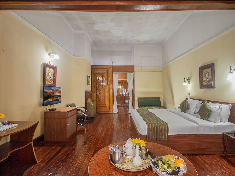 Heritage Club King Room at Central Heritage Resort & Spa, The Mall, Darjeeling - a spacious and elegant accommodation with classic decor and wooden flooring.