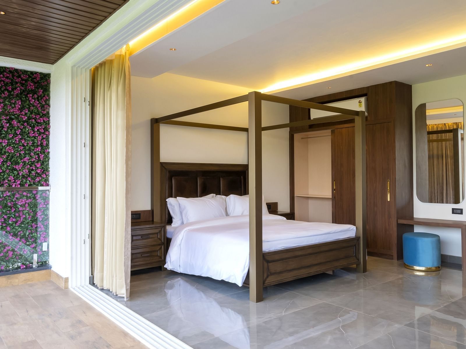 A double bed with wooden beams inside one of the rooms - The Tanisi Hotels & Resorts, Goa