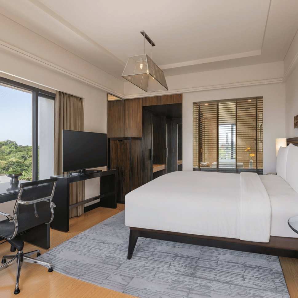 Bed with side lamps and wall decor at The Raintree, St. Mary’s Road.