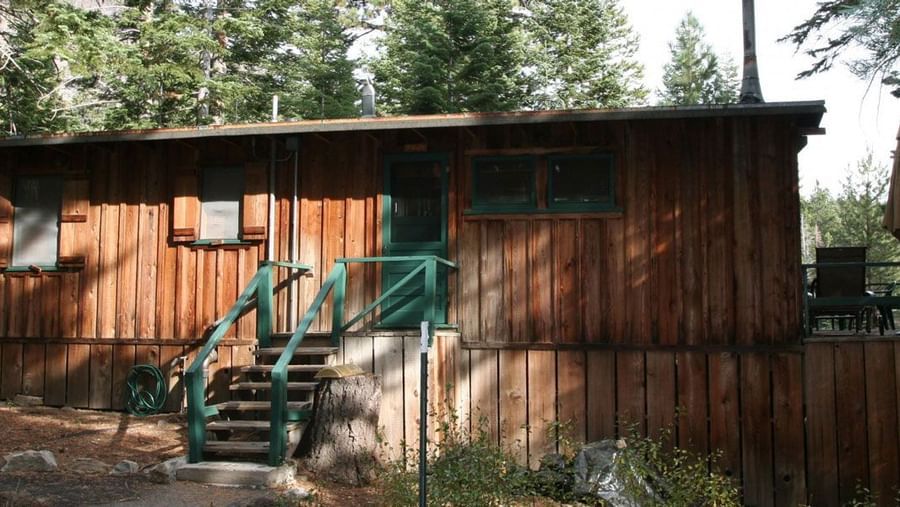A rustic wooden cabin exterior at Kit Carson Lodge.