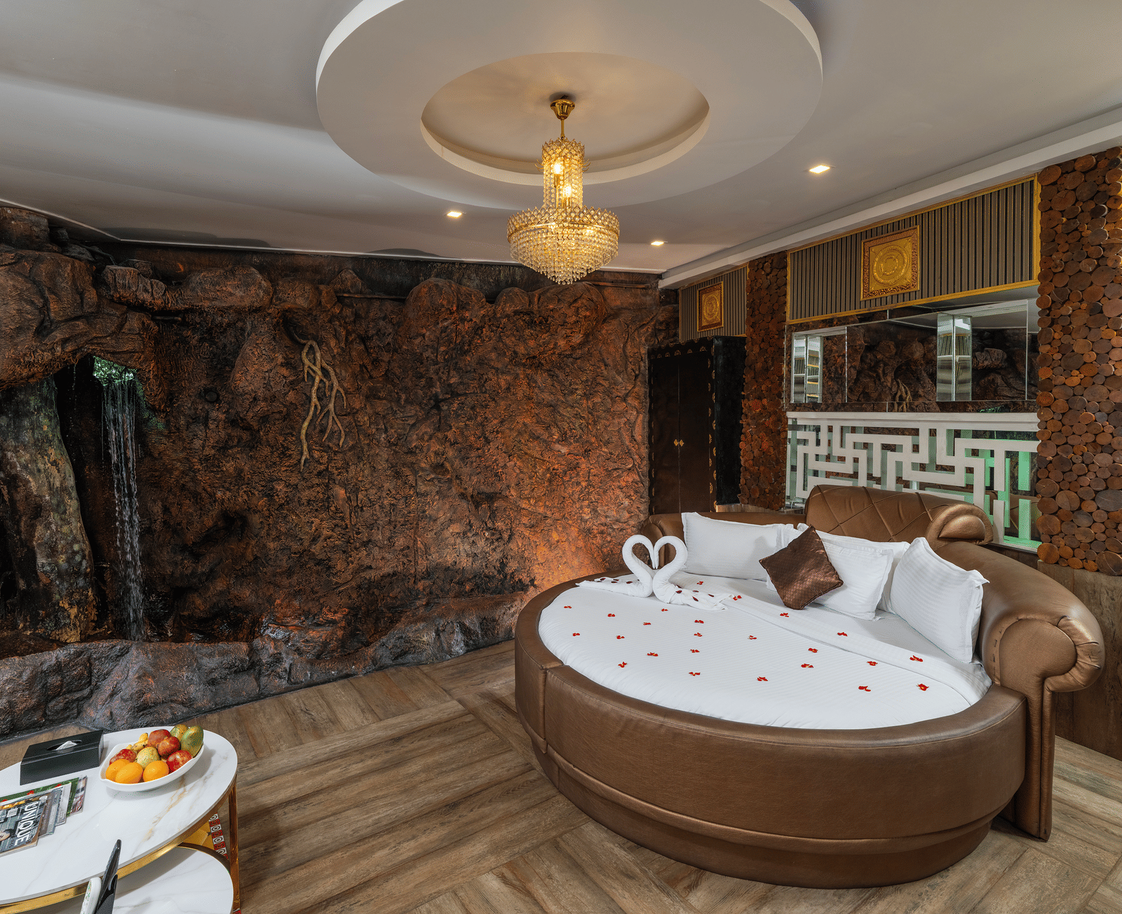 A bedroom in Single Bedroom Pool Villa at Parakkat Nature Hotel and Resorts featuring a round bed, a chandelier, and patterned tiles.