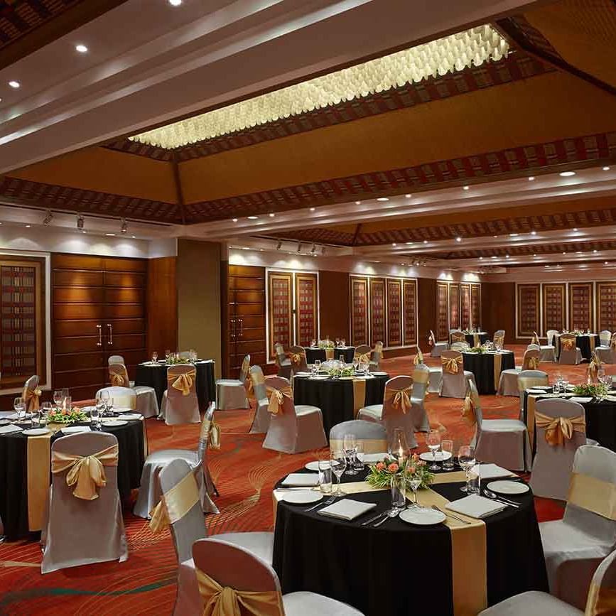 round table seating arrangements in the banquet hall at Caravela Beach Resort Goa