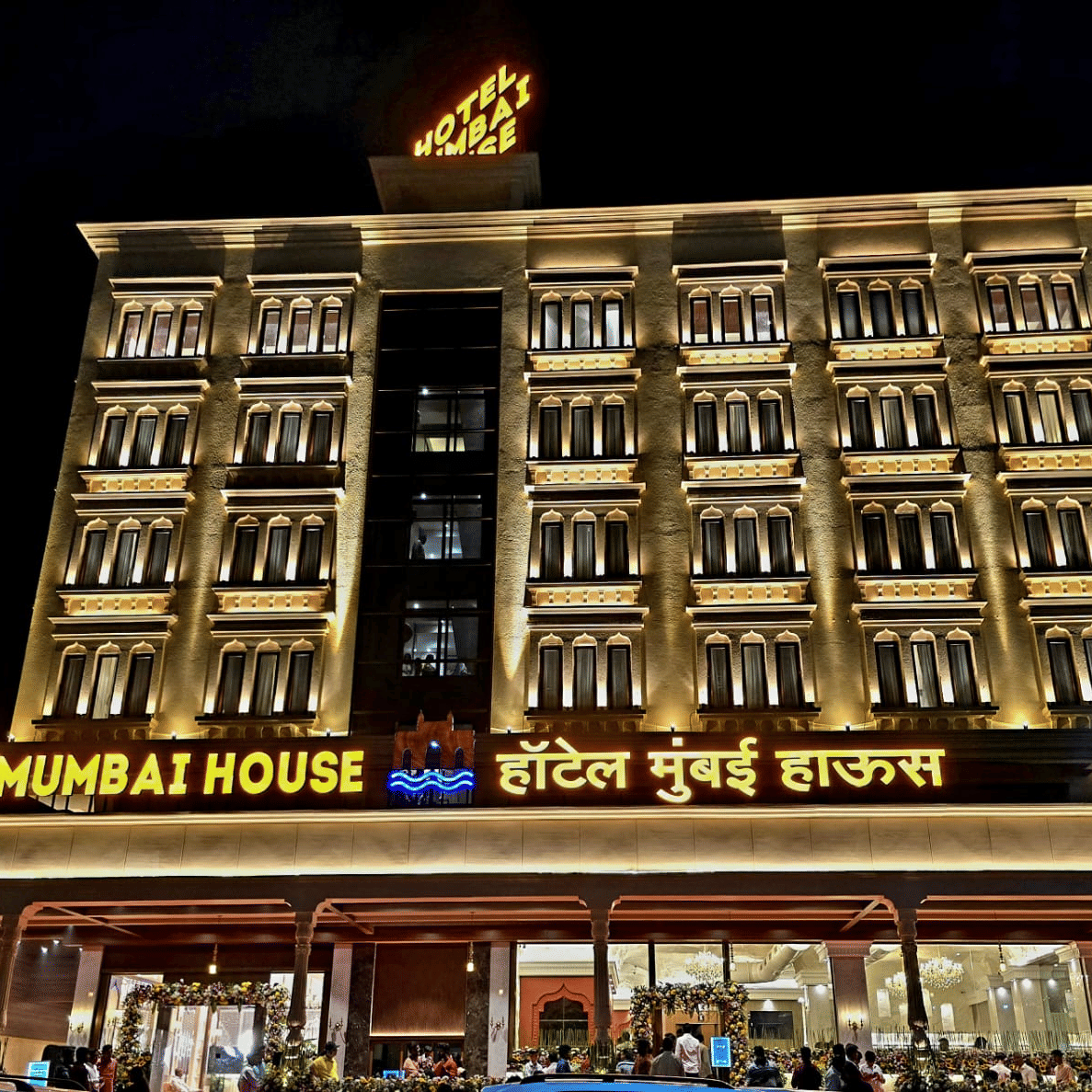 Illuminated hotel exterior at night showcasing grand façade at Hotel Mumbai House, Digha, Airoli.