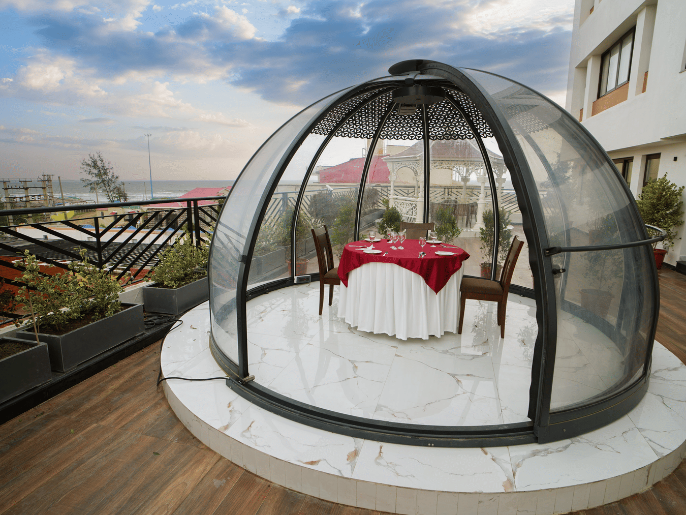 a half bubble kind of architecture with a table for two set inside it on the terrace at Shanti Seaview Resort & Spa - Hotels in Mandarmani Sea Facing
