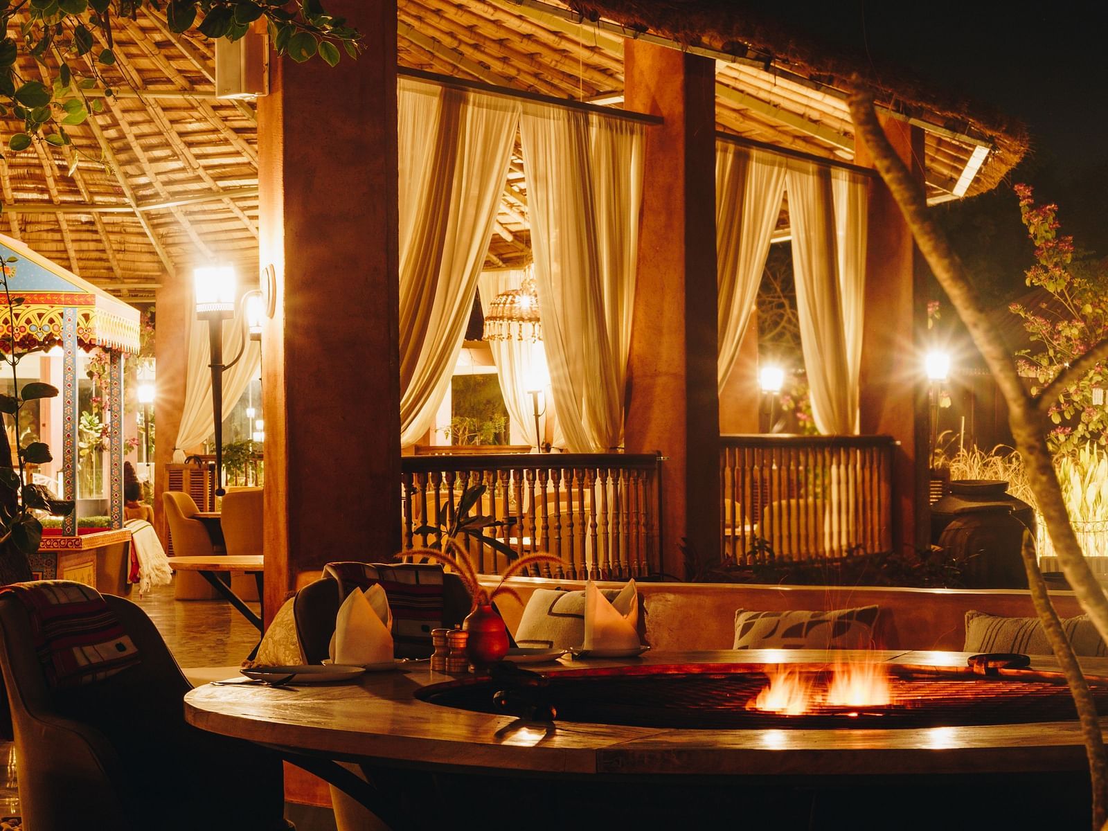 Night view of village lounge dining area at Surpura Bagh.