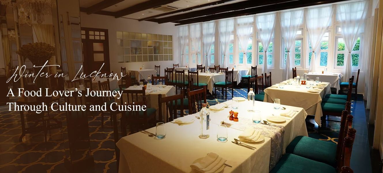 Elegant dining room with white table cloths, turquoise chairs, and large windows.