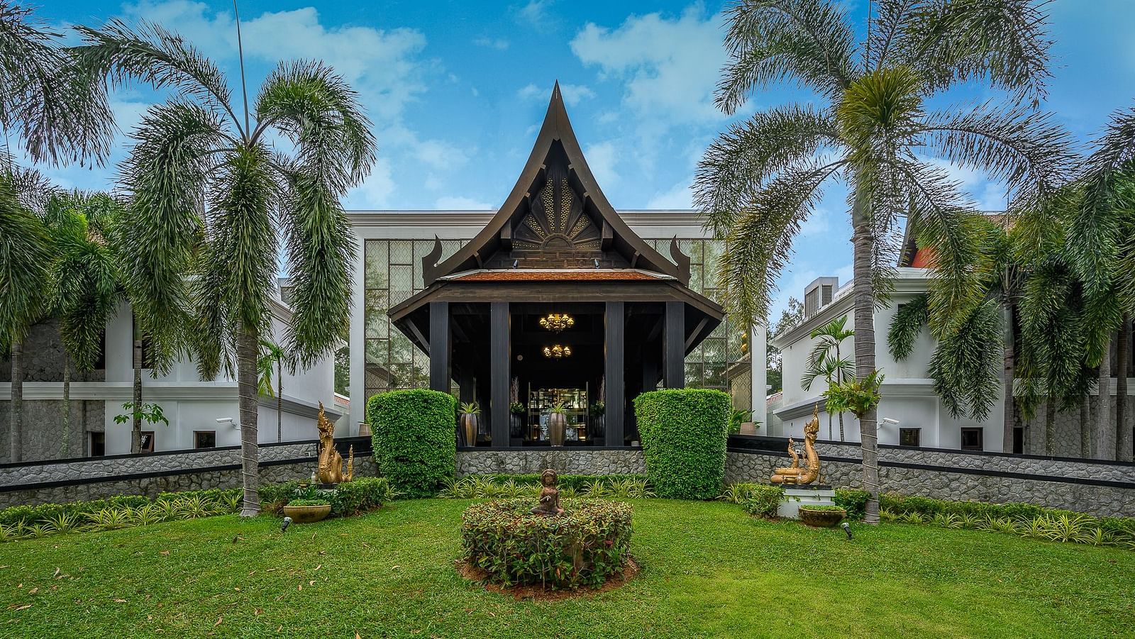 image of the entrance with a serene green lawn in the foreground - Maikhao Dream Villa Resort & Spa, Phuket