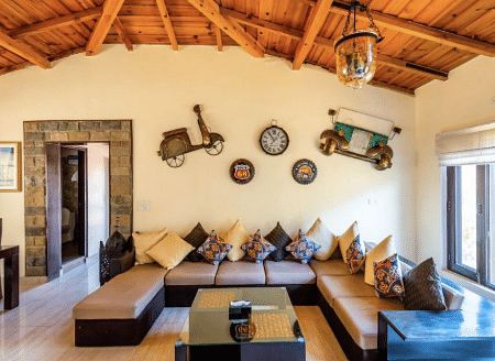 Cosy indoor lounge with wooden ceiling and ethnic decor elements at BluSalzz Collection - Suvaasa Resort, Ramgarh.