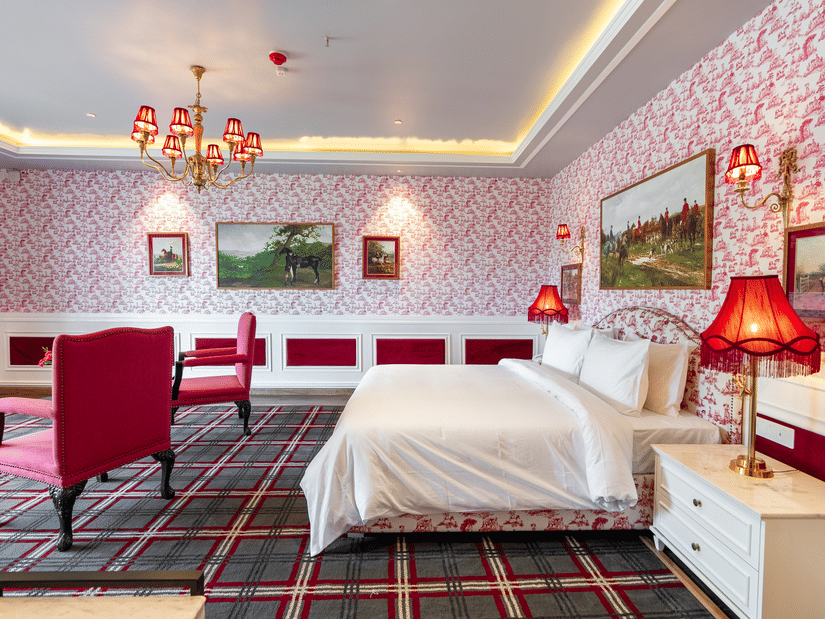 A room with a large bed and two comfy chairs in front of it  - The Manor Luxury Hotel, Shimla