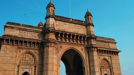a close up image of the gateway of India with blue sky in the background