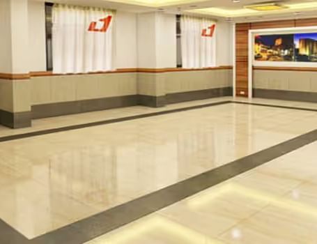 View of banquet hall called The Durbar with polished flooring and ample space for events - Max Hotel Prayagraj.