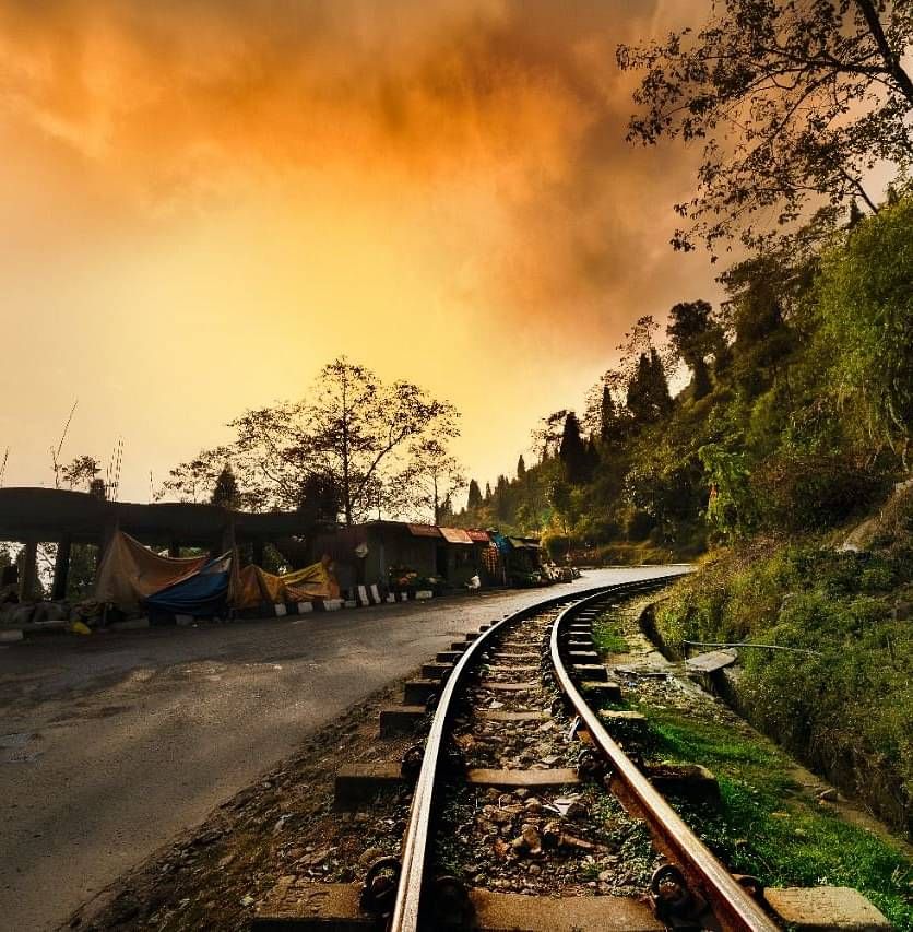 A view of the railway tracks on the hills at sunset.