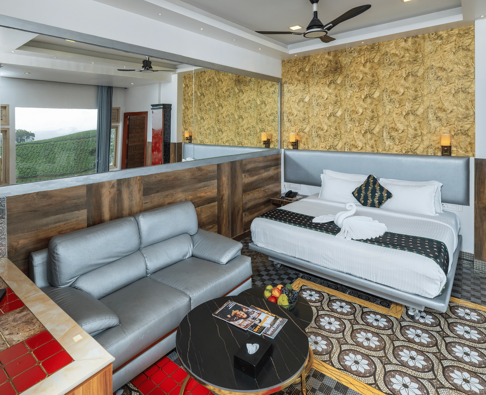 A bedroom in 2 Bedroom Pool Villa at Parakkat Nature Hotel and Resorts, Munnar, featuring a double bed, a 2 seating sofa, a round table, and patterned tiles.