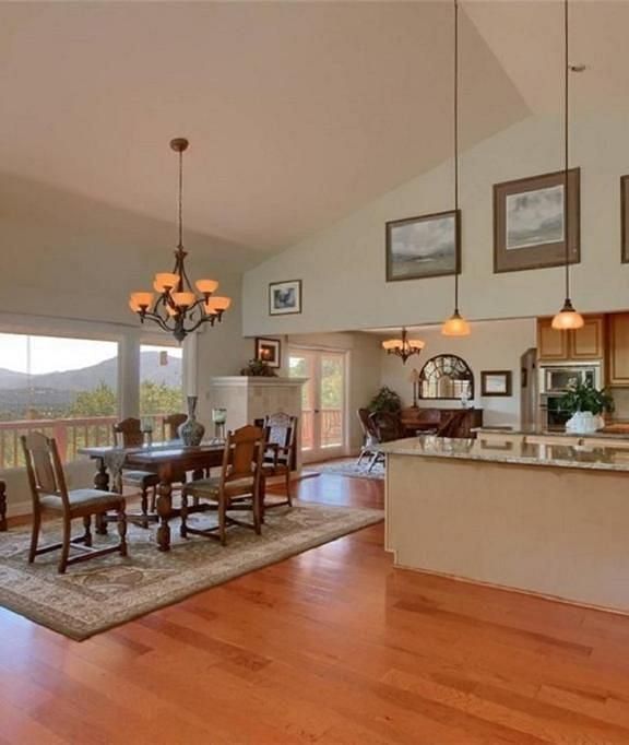 A view of the dining area of a room at Narrow Gauge Inn besides the kitchen with large French windows.