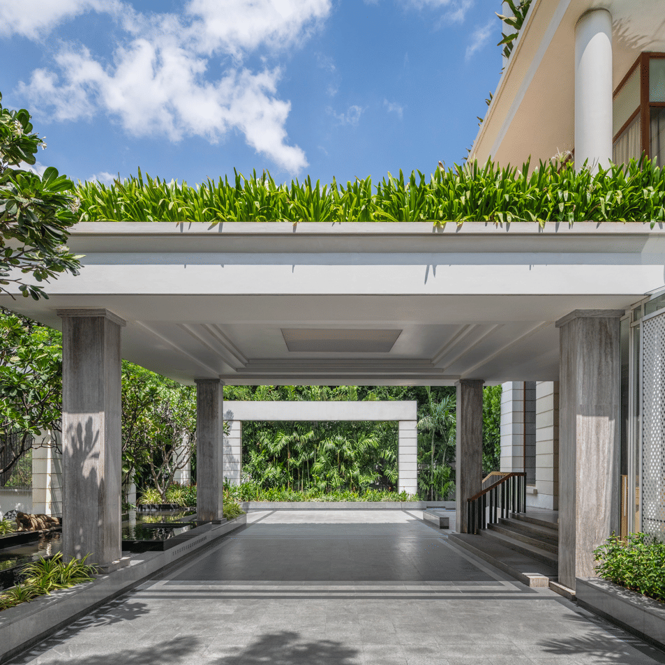 Covered driveway with plants and hotel entrance at The Raintree, St. Mary’s Road.