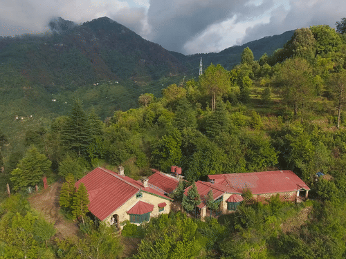 Bird's eye view of the bungalows surrounded by majestic mountains - Ramgarh Bungalows, Nainital.