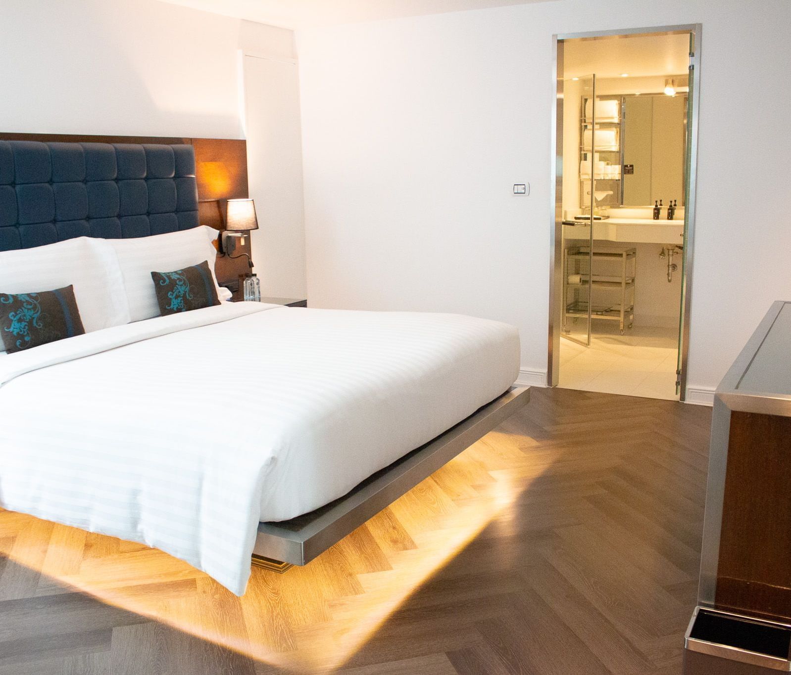 Bedroom at Night Hotel Bangkok with king bed and warm ambient lighting.