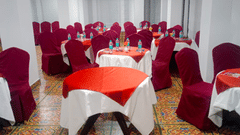 Interior of a hall with round tables surrounded by chairs