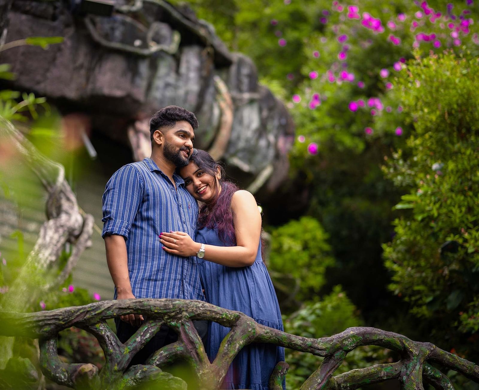 a couple in a scenic place with greenary and violet flowers