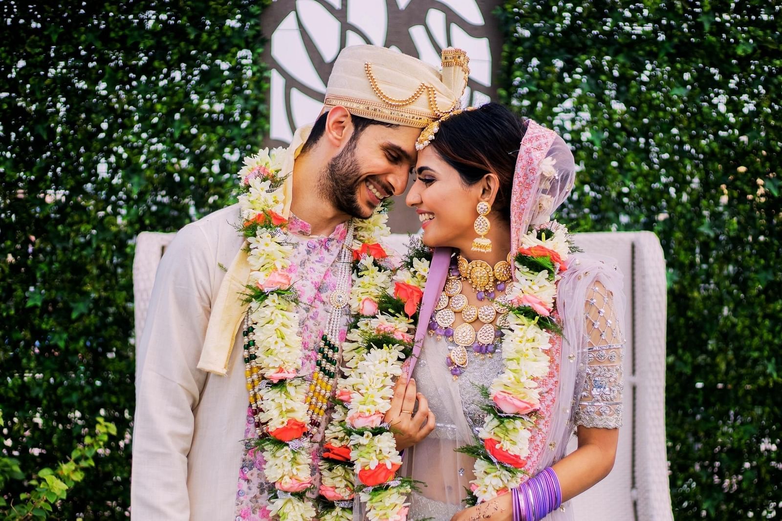 a Couple posing for a picture after getting married - Rhythm Kumarakom