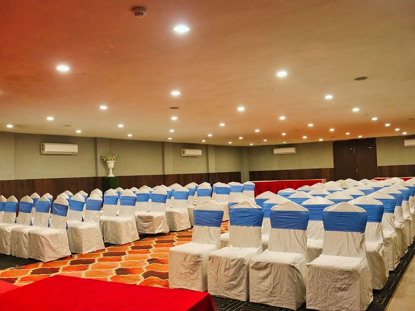 The banquet hall is set up with round seating tables at Clarks Collection, Bhavnagar