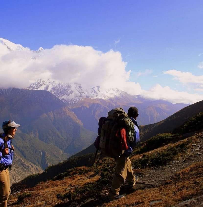 People trekking on a hill. 
