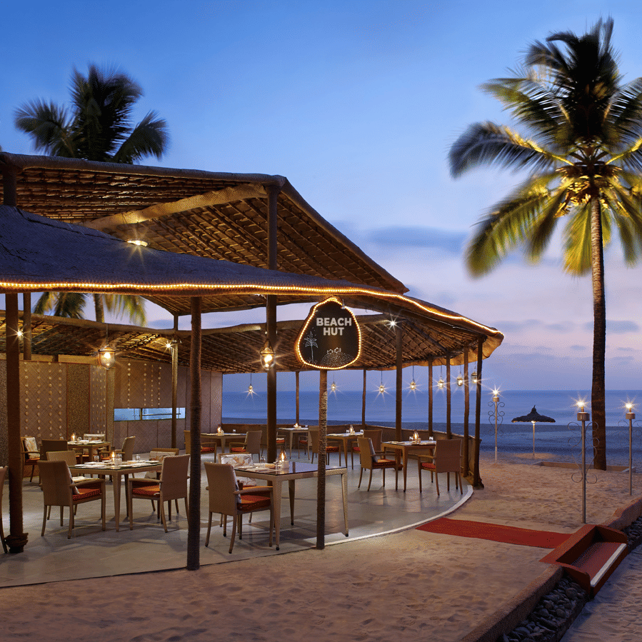 overview of the Beach Hut with a coconut tree on the side - Caravela Beach Resort Goa