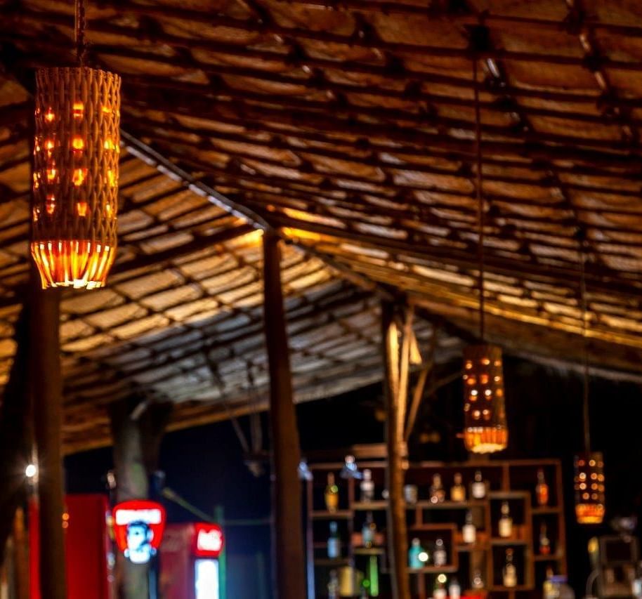 a close up shot of the light hung above inside a shack - Caravela Beach Resort Goa