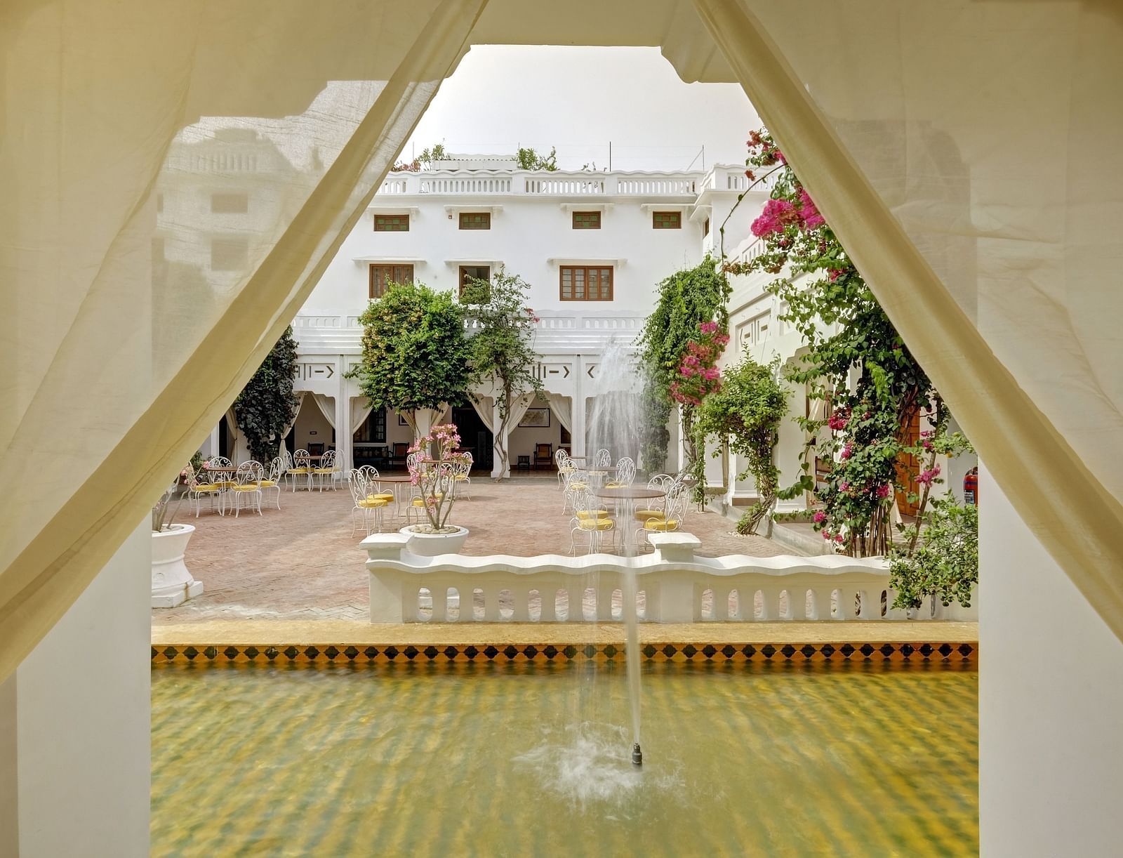 A view from inside of the hall Sehen with a fountain in view - Saraca Hotel Lucknow.