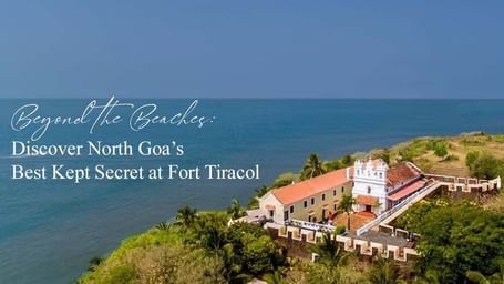 Aerial view of Fort Tiracol on a cliffside overlooking the Arabian Sea, text overlay: Beyond the Beaches: Discover North Goas Best Kept Secret at Fort Tiracol.