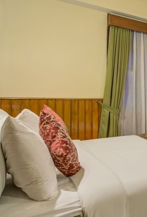 Image of a room with bed and windows on two sides of the room at Summit Tashi Ghang Heritage Resort, Pelling