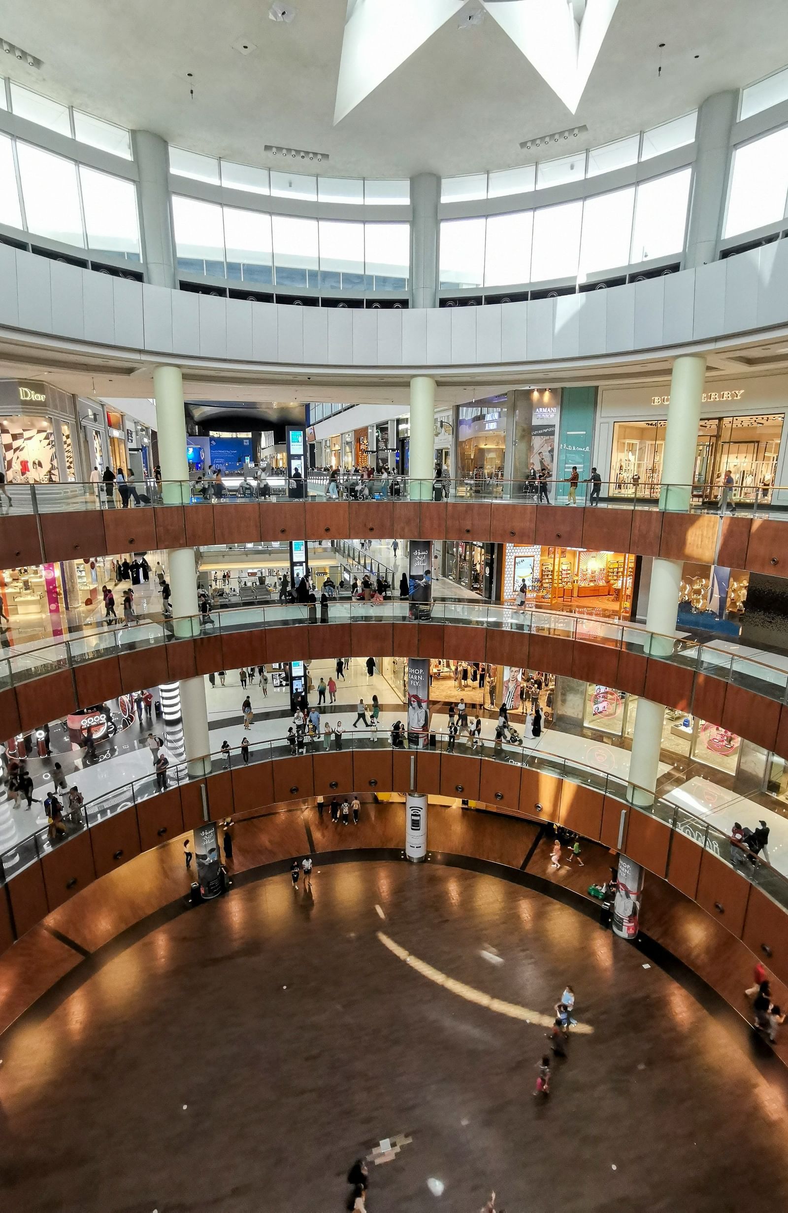 An image of multi storey mall featuring several stores 