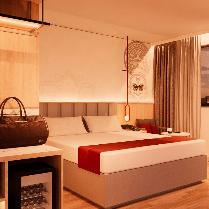 A close up shot of the plush bed in a room with warm lighting at TGI Oberon, Koramangala
