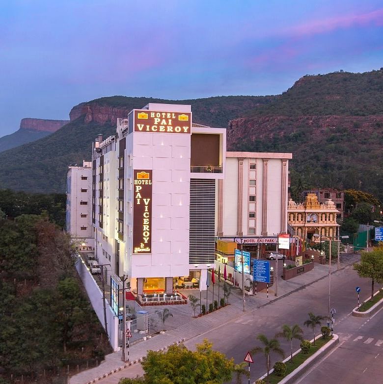 A image of a Hotel Pai Viceroy Tirupathi builiding which is set amidst the hills and greenery 