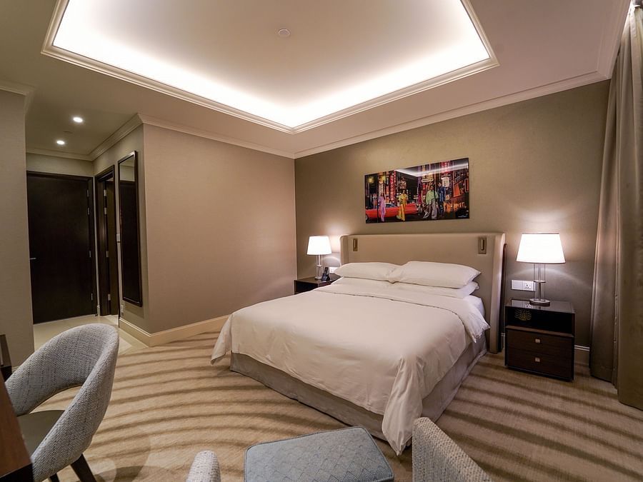 Address Dubai Mal(previously Address Fountain Views) Residence Tower - view of a king size bed from the sofa seats kept in one corner of the room