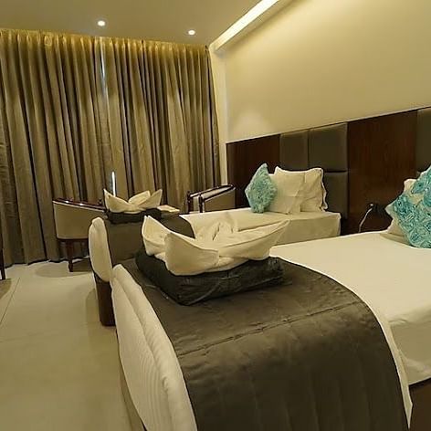 A side view of twin beds with bedding