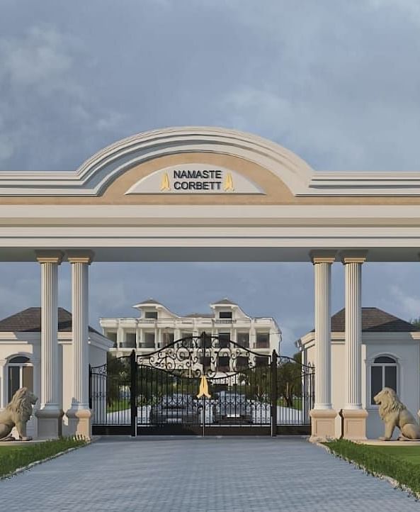 The entry gate to Namaste Corbett, flanked by greenery.