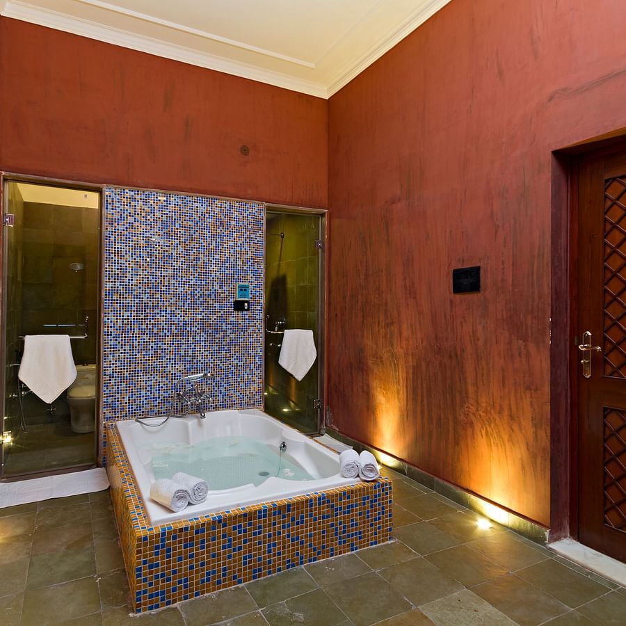spa room with a bath and towels - Hotel Castle Mandawa, Jhunjunu